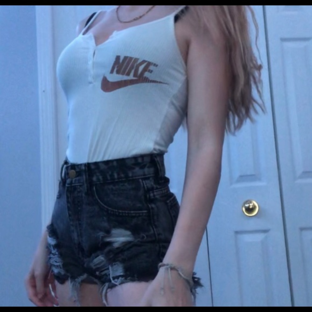 white and orange nike body suit